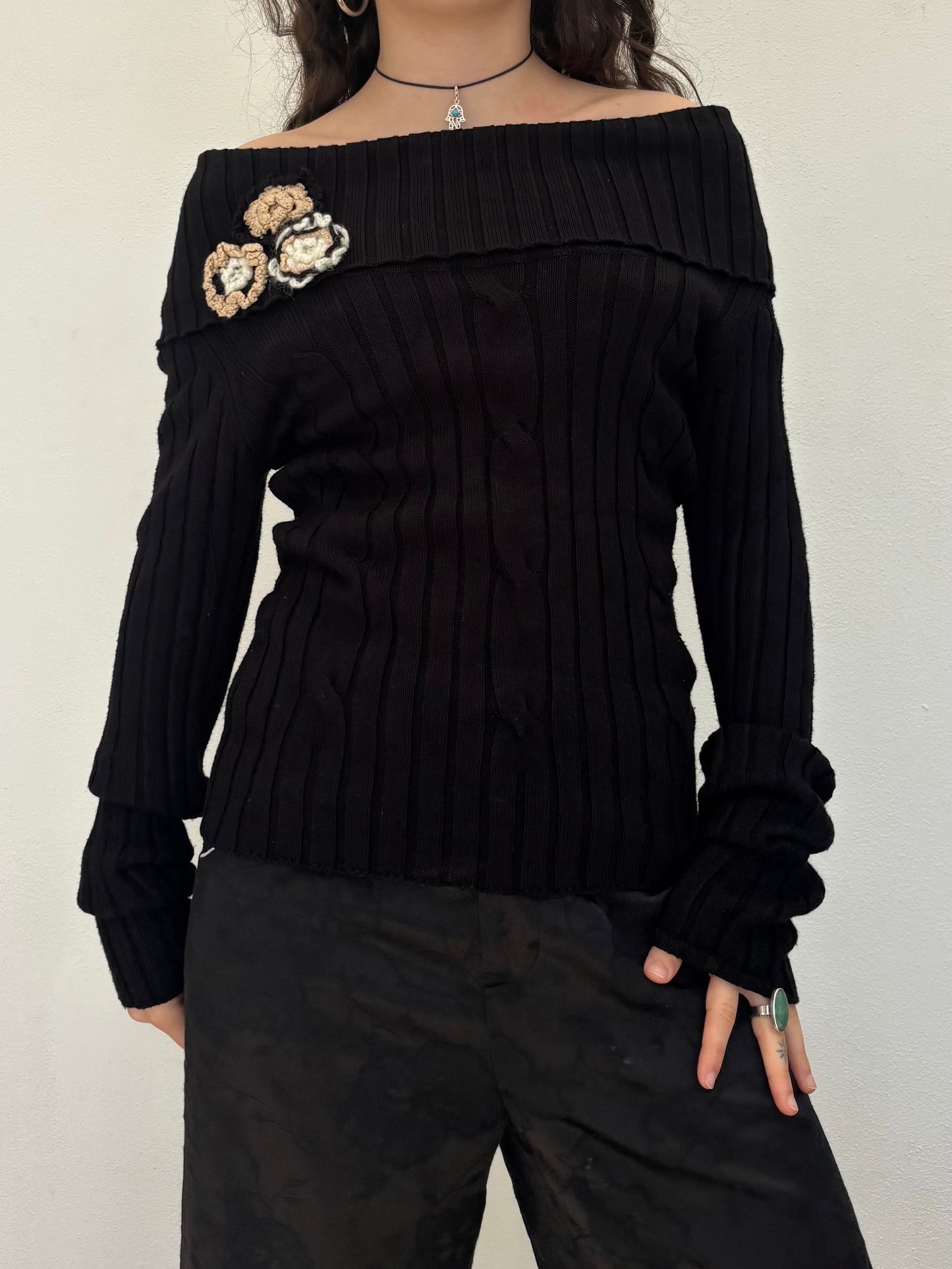 Black off the shoulder knit top with flower details