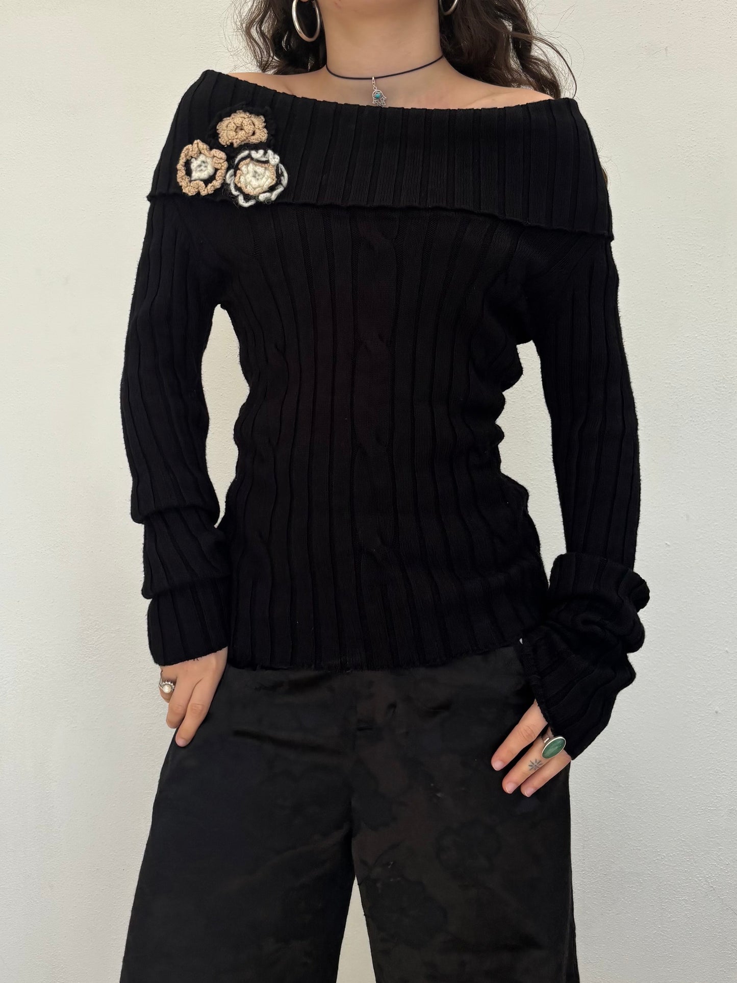 Black off the shoulder knit top with flower details