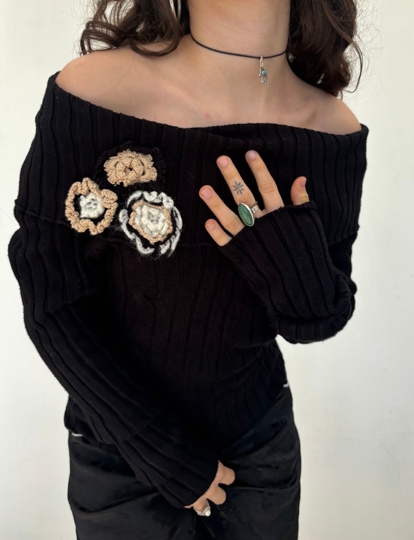 Black off the shoulder knit top with flower details